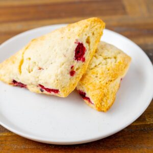 Two raspberry scones on a plate. These delicious scones are available at Simply Baked Catering Inc. in Winchester, Ontario.